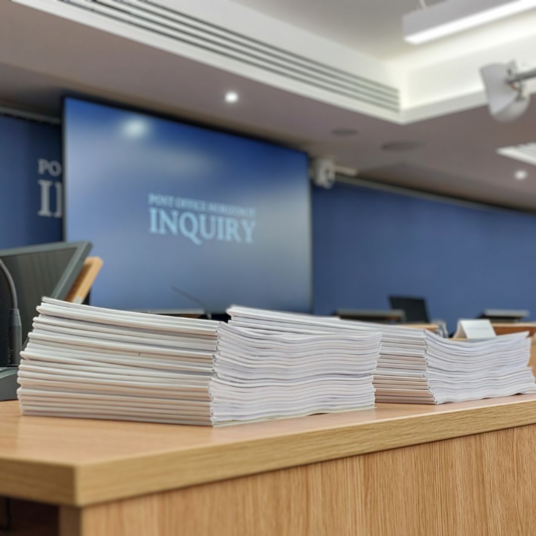 Table showing stack of papers in Post Office Horizon IT Inquiry hearing room