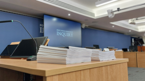 Stack on interim reports in the Inquiry hearing room